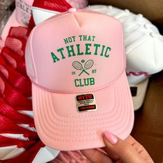 Not That Athletic Club Foam Trucker Hat in Light Pink - Giddy Up Glamour Boutique Cheap Team-colored Trucker Hat For Fans, Trendy Sports Trucker Hat, Graphic Trucker Hat, Trendy Trucker Hat For Baseball Season With Flat Bill, Trendy Flat Bill Trucker Hat For Baseball Season, Casual Trucker Hat For Sports Events In Spring, Trendy Snapback Hat For Sports, Trendy Spring 5-panel Trucker Hat, Pink Casual Trucker Hat For Sports Events