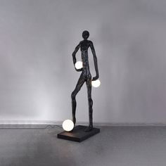 a black and white statue with three lights on it