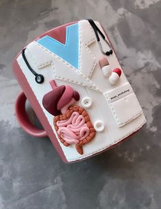 a coffee cup decorated like a doctor's coat and stethoscopes