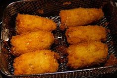 some fried food is in a basket on the stove