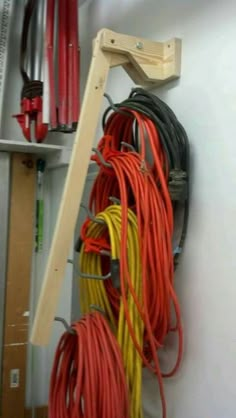 there are many wires on the wall next to each other and one is red, yellow, and orange