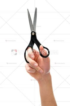 a person holding a pair of scissors in their right hand and pointing it at the camera