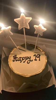 a birthday cake with white frosting and three stars on top that say happy 19