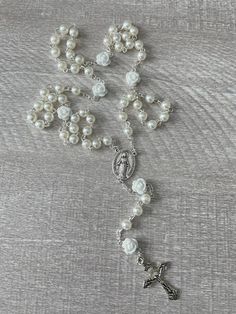 Handcrafted Catholic prayer rosary. Traditional chain style five decade rosary.  It is made with a delicate silver plated crucifix and matching silver Virgin Mary medallion with white rose beads and 6mm faux pearls. Each bead is hand placed, turned and connected.  This rosary is perfect for a bridal rosary, Holy Communion or Confirmation Rosary.  Handmade in Florida with love. ❤️ Silver Crucifix For Wedding, Silver Pearl Rosary For First Communion, Silver Miraculous Medal For Wedding, Silver Miraculous Medal Jewelry For Wedding, Rosary Garden, Plant City, Rosary Catholic, Virgin Mary, Last Minute Gifts