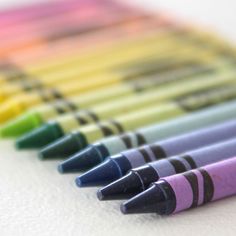 several different colored crayons lined up in rows