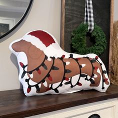 a decorative dog pillow sitting on top of a dresser