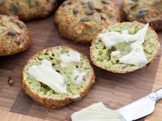 some food is sitting on a cutting board with a spatula next to the muffins