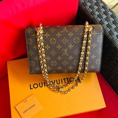 Authentic Louis Vuitton.Bought It Brand New. Gold Chain Shoulder Or Crossbody Bag.Monogram With Smooth Black Colored Leather,Gold Hardware,Metal Clasp Closure ,Outside Pocket And Gold Chain Strap Not Removable.It Comes With Box And Dust Bag. Travel Shoulder Bag With Chain Strap And Monogram Canvas, Monogram Canvas Shoulder Bag With Chain Strap For Travel, Luxury Monogram Canvas Shoulder Bag For Everyday, Luxury Monogram Canvas Shoulder Bag, Luxury Gold Monogram Canvas Shoulder Bag, Gold Monogram Canvas Shoulder Bag With Chain Strap, Rectangular Monogram Canvas Shoulder Bag With Chain Strap, Travel Bag With Chain Strap And Monogram Canvas, Luxury Shoulder Bag In Monogram Canvas With Original Box