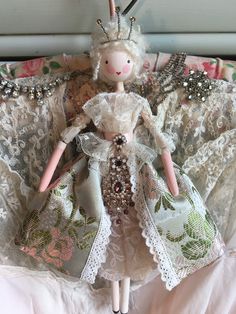 the doll is wearing a tiara and dress