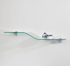 a glass shelf with a toothbrush on it