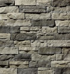 a stone wall that is made out of different types of rocks