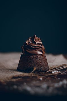 a chocolate cupcake sitting on top of a table