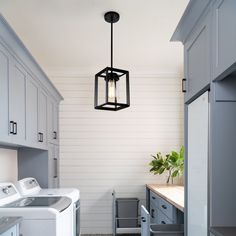 a laundry room with washer, dryer and cabinets