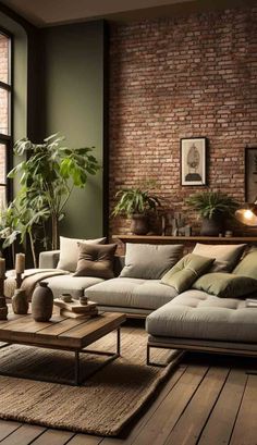 a living room filled with lots of furniture and plants on top of a wooden floor