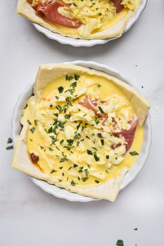 two plates filled with food sitting on top of a white countertop next to each other