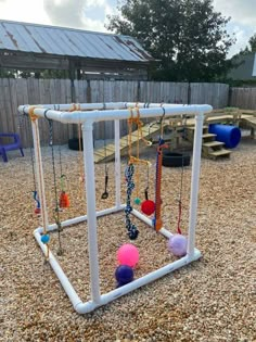 an outdoor play area with swings and balls