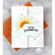 a greeting card with the words sending sunshine on it and a sun in the clouds