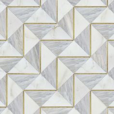 a white and grey marble tile with gold trim