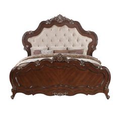 a bed with an ornate headboard and foot board