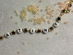 beads spelling out the word nativity on a white surface with gold and silver decorations