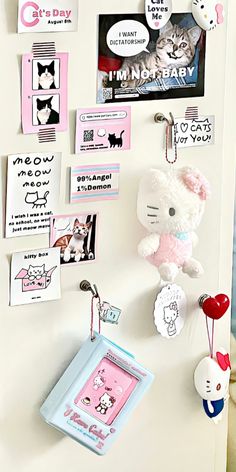 a refrigerator with magnets and pictures on the door, including a hello kitty keychain