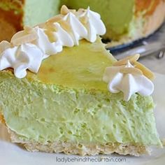 a piece of green and white cake on a plate with a slice missing from it