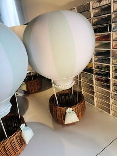 two hot air balloons are in baskets on the floor