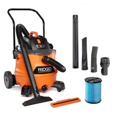 an orange and black vacuum is next to cleaning supplies