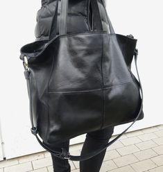 Leather bag in black, soft and big. The front decorative stitching Bag Zippered. Handles 58 cm. Complete with a long strap, you can adjust the length to be worn on the arm, max. l. 110 cm. Leather soft, genuine leather, high quality. In the middle the lining; inside a large zip pocket and a smaller leather pocked on the phone. h. 34cm, width 54 cm, depth of 16 cm . If you want a bag of this leather in other dimensions - write in the comments to the order, the price does not change. Free standard Leather Hobo Bag Backpack With Large Capacity, Black Leather Large Capacity Backpack, Large Capacity Black Leather Backpack, Versatile Black Soft Leather Bag, Black Leather Hobo Bag For Travel, Black Soft Leather Bag For Daily Use, Black Soft Leather Bag With Double Handle, Black Hobo Satchel For Errands, Black Leather Hobo Bag For Errands