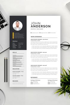 a professional resume template with a black and white color scheme on the cover, sitting next to a laptop