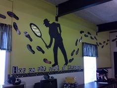 there is a large mural on the wall in this restaurant that depicts a man holding a tennis racket