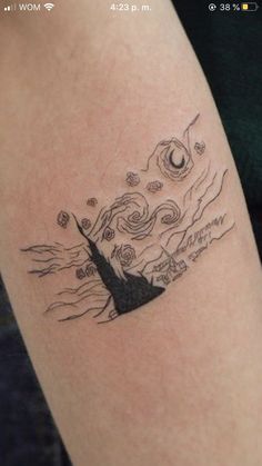 a woman's arm with a tattoo on it that has an image of a mountain