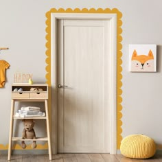 a baby's room with an orange and yellow wall decal on the door