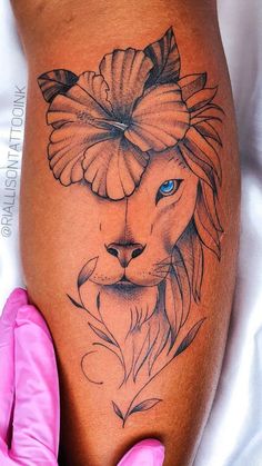 a woman's thigh with a lion tattoo on it