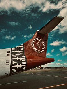 the tail end of an airplane with designs on it