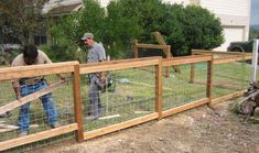 two men working on a fence in the yard