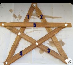 an image of a star made out of wood with numbers in the middle and four sides