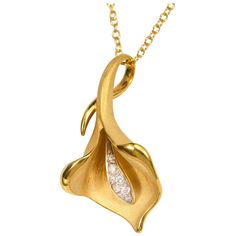 From Annamaria Cammilli's Calla collection, Calla flower shaped pendant necklace handcrafted in 18 karat Sunrise Yellow gold. Hand crafted of polished and satin textured gold, with diamonds. Diamond total weight is 0.09 carat. Pendant dimensions are 30 millimetres tall, 16 millimetres wide and 9 millimetres deep. Chain is 18 karat yellow gold with lobster claw, and measures 18" (45 cm) and can also be worn at 16" (40 cm). Sculpted in Florence, Italy, the Annamaria Cammilli brand is well known fo Exquisite Gold Necklace With Large Pendant, Formal Necklace With Polished Flower Pendant, Yellow Gold Flower Pendant Necklace With Polished Finish, Yellow Gold Necklace With Flower Pendant And Polished Finish, Formal Flower Pendant Necklace With Polished Finish, Elegant Necklaces With Flower Pendant And Polished Finish, Formal Yellow Gold Flower Pendant Necklace, Elegant Flower Pendant Jewelry With Polished Finish, Elegant Yellow Gold Diamond Necklace With Large Pendant