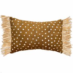 a brown pillow with white polka dots on it