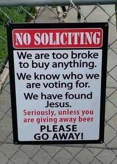 a no soliciting sign posted on a chain link fence