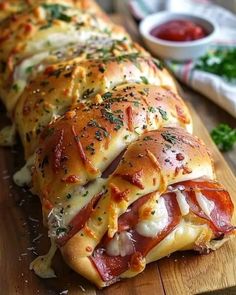 a cheesy ham and cheese roll on a cutting board