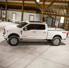 a white pickup truck parked in a garage