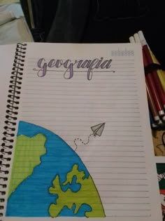 an open notebook with the word geogracia written on it