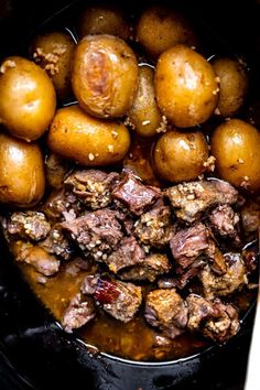 some meat and potatoes are in the slow cooker