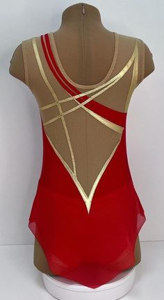 the back of a woman's leotard with gold and red trims