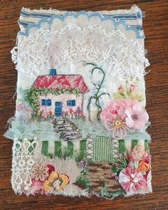 a piece of fabric with flowers and a house on it