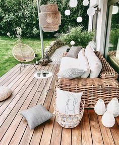 a wicker couch sitting on top of a wooden deck