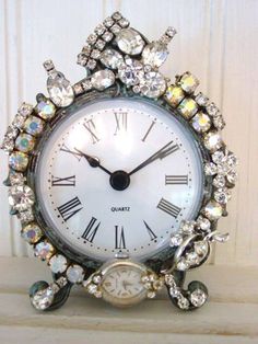 an ornate clock with crystals on the face