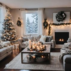 a living room decorated for christmas with candles and wreaths on the fireplace mantel