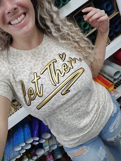 a woman is standing in front of some crafting supplies and posing for the camera